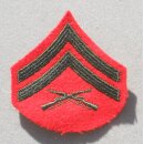 Corporal USMC Rank Insignia subdued on sand, used